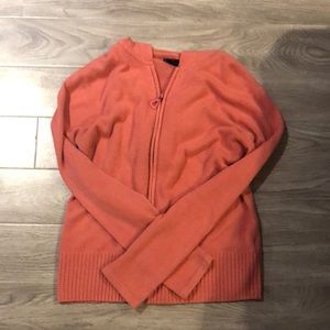 Pink zip up sweater.